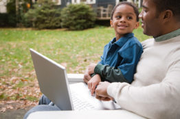 Father and son with laptop